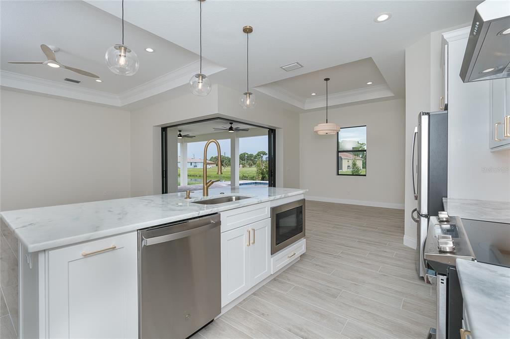 191 Tournament Road Rotonda West, FL 33947 - Photo 24 of 41 a kitchen with a stove sink and refrigerator