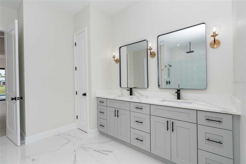 191 Tournament Road Rotonda West, FL 33947 - Photo 31 of 41 a bathroom with a double vanity sink and mirror
