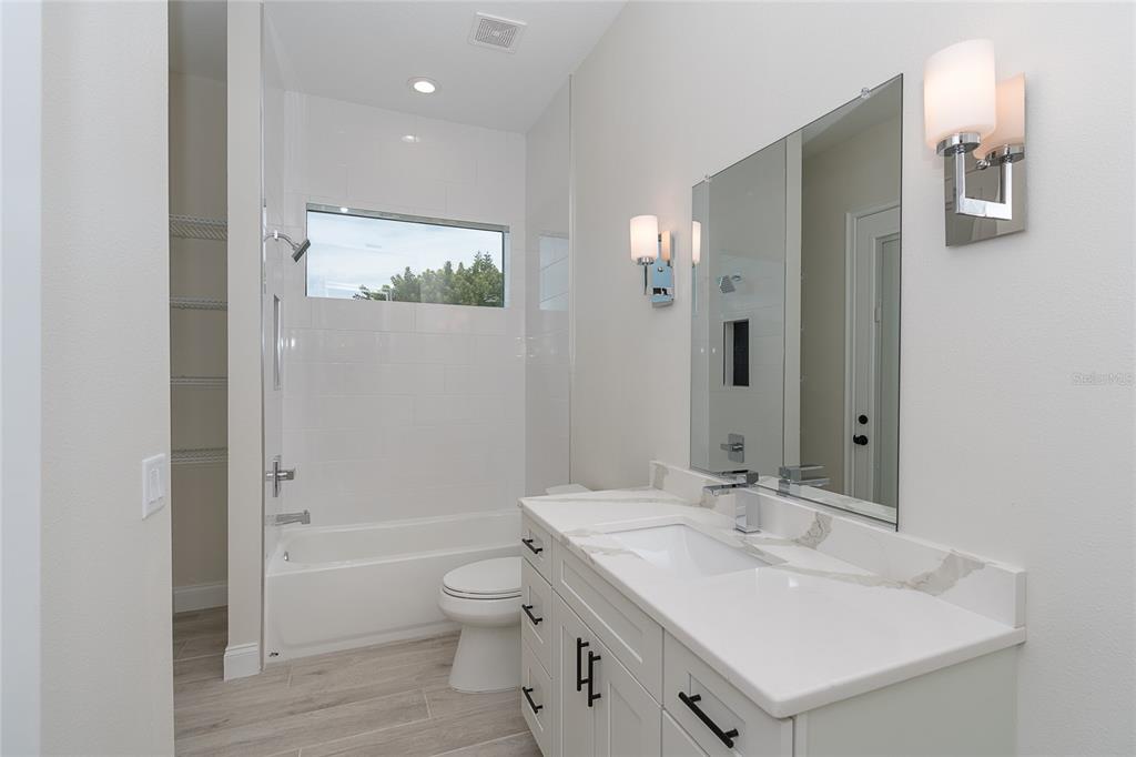 191 Tournament Road Rotonda West, FL 33947 - Photo 33 of 41 a bathroom with a sink a toilet and shower