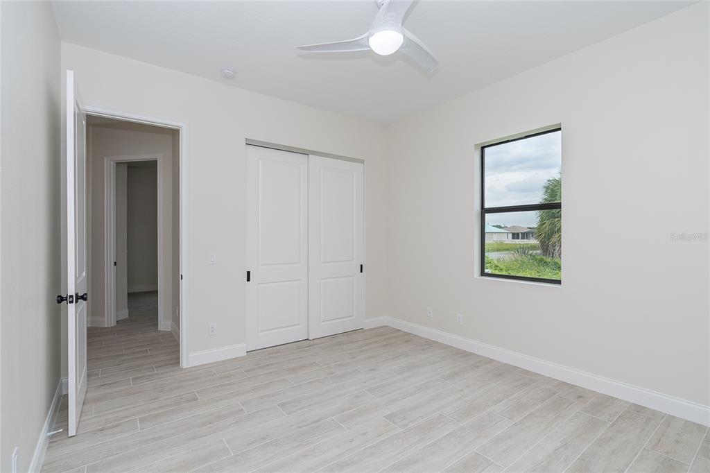 191 Tournament Road Rotonda West, FL 33947 - Photo 34 of 41 an empty room with wooden floor and window