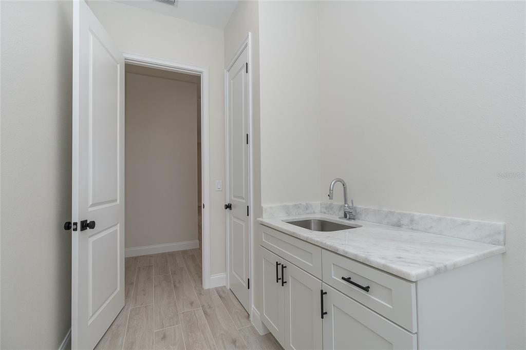 191 Tournament Road Rotonda West, FL 33947 - Photo 36 of 41 a bathroom with a granite countertop sink and a mirror