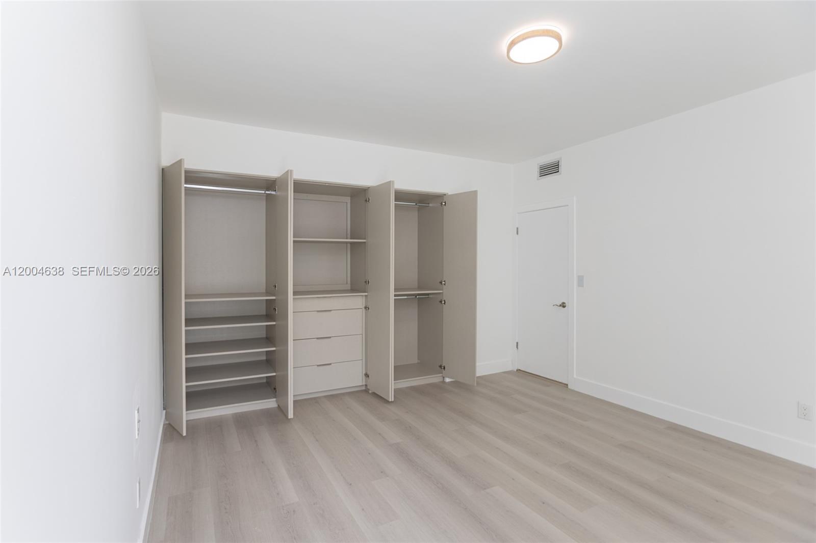 1690 Daytonia Road Miami Beach, FL 33141 - Photo 45 of 88 a view of walk in closet with empty racks