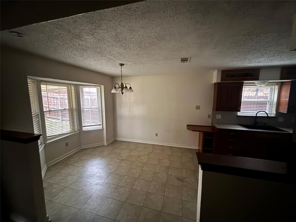 5916 Birchhill Road Watauga, TX 76148 - Photo 4 of 12 a view of room with a flat screen tv and windows