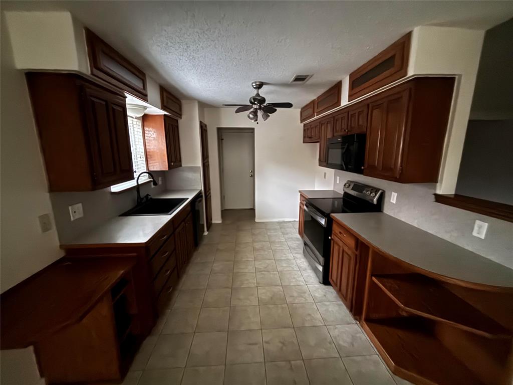 5916 Birchhill Road Watauga, TX 76148 - Photo 5 of 12 a hallway with a large storage and utility