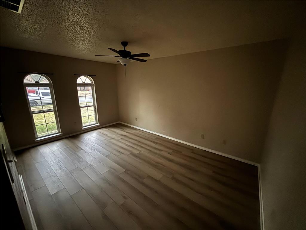 5916 Birchhill Road Watauga, TX 76148 - Photo 7 of 12 wooden floor in an empty room with a window