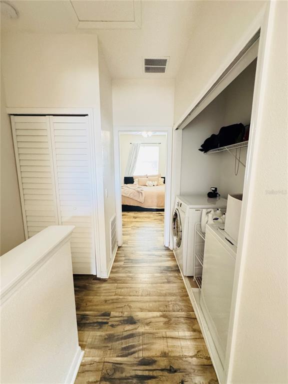 3660 Wilshire Way Road, Unit 260 Orlando, FL 32829 - Photo 12 of 25 a hallway with white cabinets and wooden floor