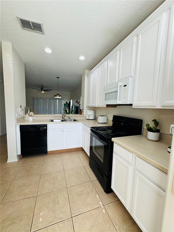 3660 Wilshire Way Road, Unit 260 Orlando, FL 32829 - Photo 4 of 25 a kitchen with a cabinets and appliances