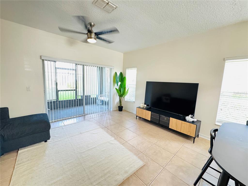 3660 Wilshire Way Road, Unit 260 Orlando, FL 32829 - Photo 7 of 25 a living room with furniture and a flat screen tv