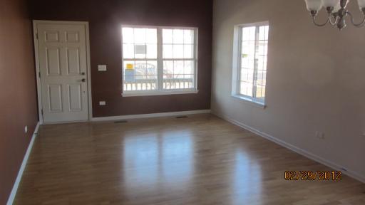 1663 Cesario Drive Hampshire, IL 60140 - Photo 3 of 14 an empty room with wooden floor and windows