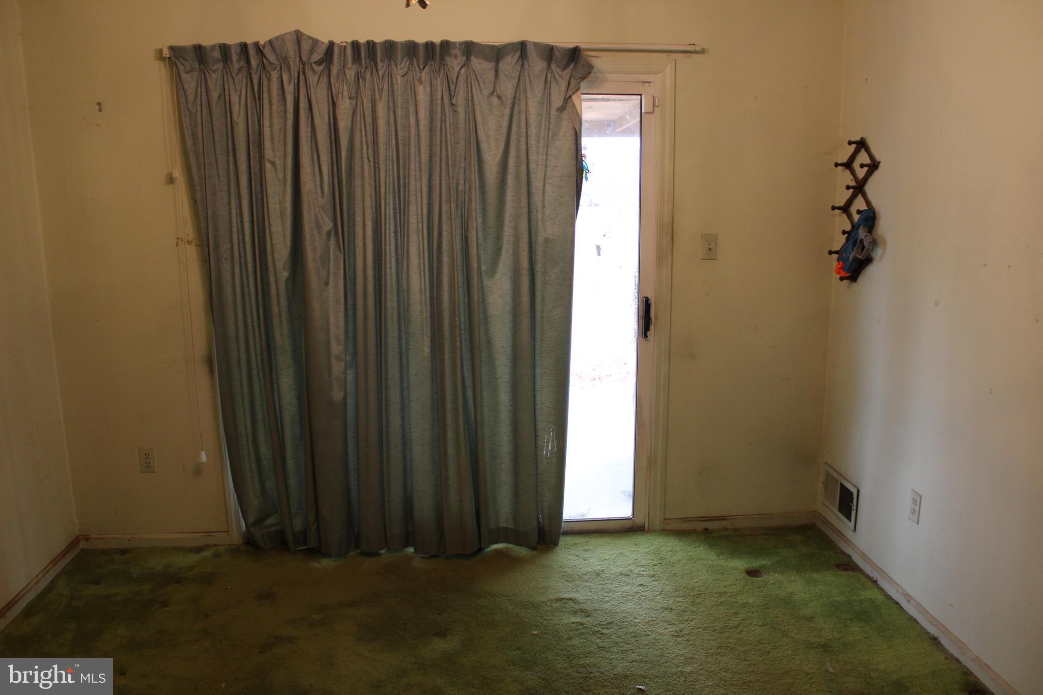 6815 Rolling Road Springfield, VA 22152 - Photo 6 of 22 an empty room with a wooden door