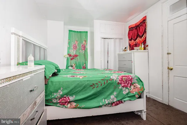 a bedroom with a bed and dresser