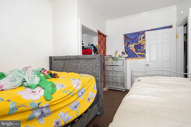 a bedroom with a bed and dresser