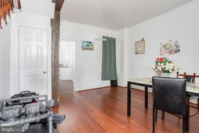 a dining room with furniture and wooden floor