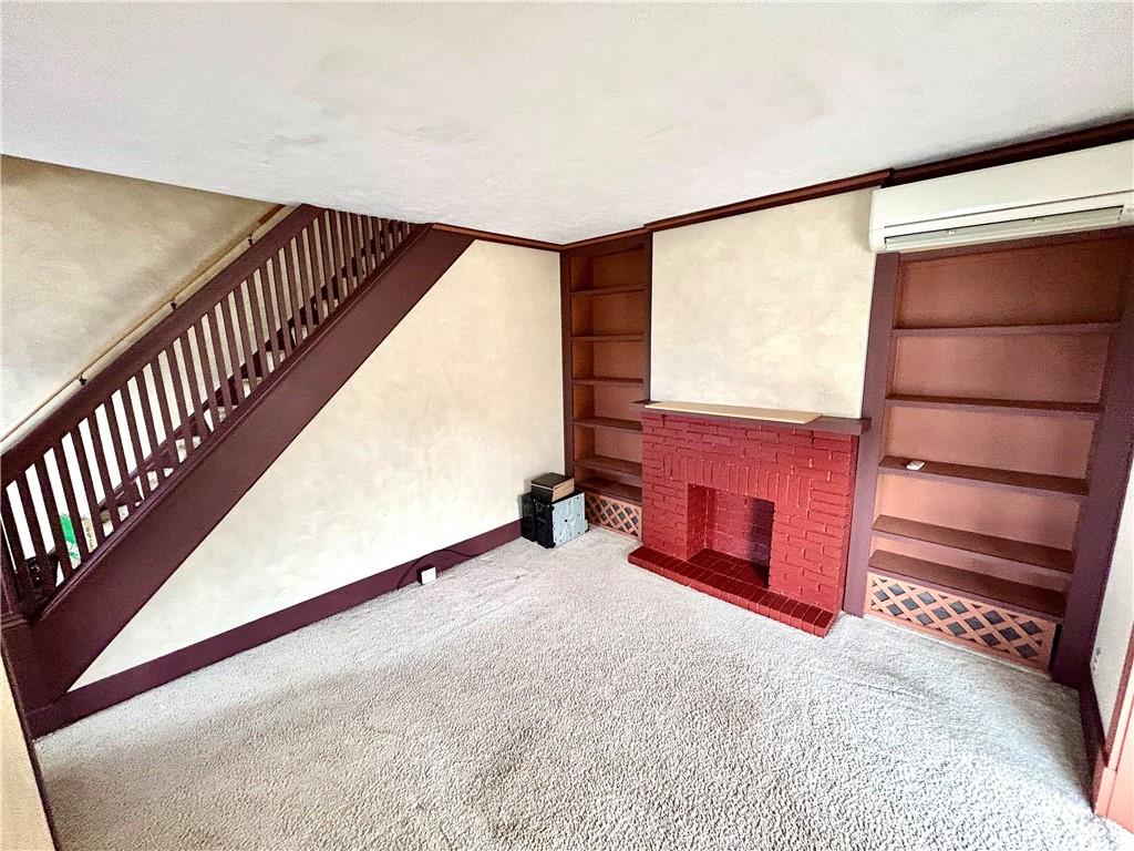 142 Hamilton Avenue Vandergrift, PA 15690 - Photo 4 of 27 Nice living room. The staircase has original woodwork.
