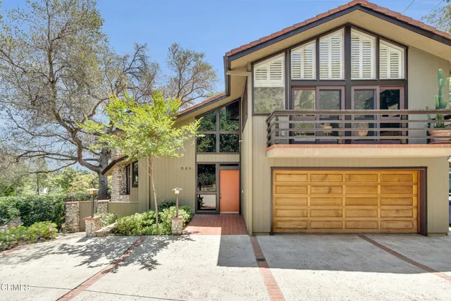 a front view of a house with glass windows and door