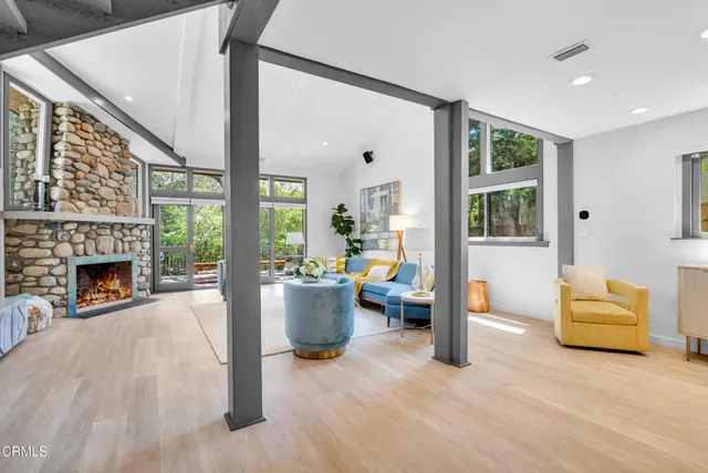 a living room with furniture and a fireplace