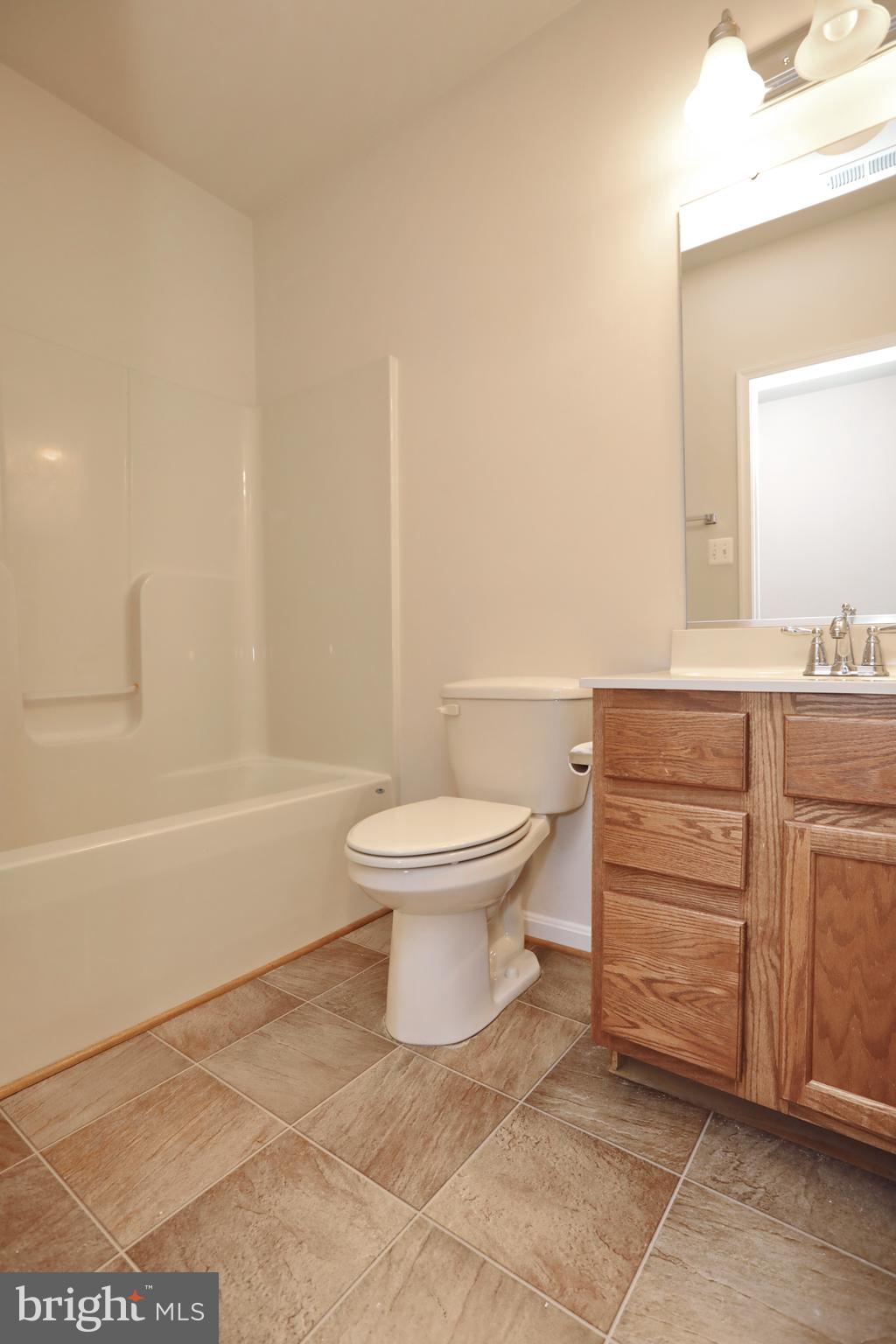 7580 Knotting Hill Lane Port Tobacco, MD 20677 - Photo 24 of 30 a bathroom with a toilet a sink and a bathtub