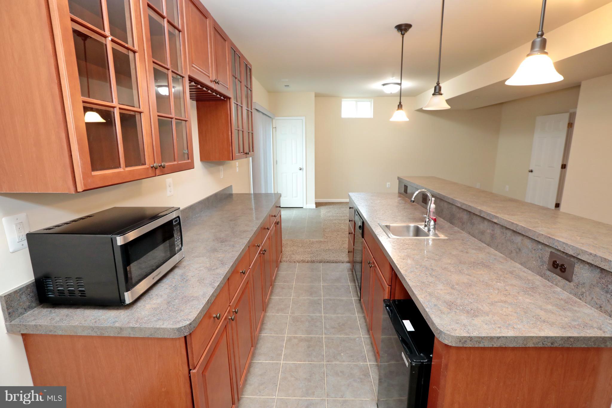 7580 Knotting Hill Lane Port Tobacco, MD 20677 - Photo 27 of 30 a kitchen with stainless steel appliances granite countertop a sink and a microwave