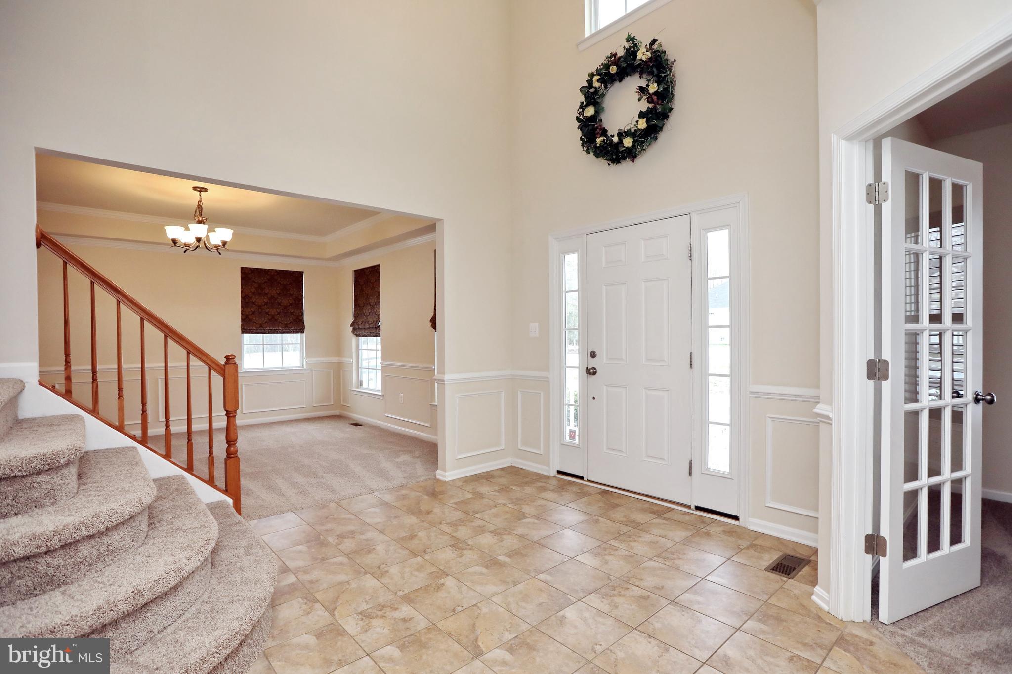 7580 Knotting Hill Lane Port Tobacco, MD 20677 - Photo 6 of 30 wooden floor in an entryway with a chandelier