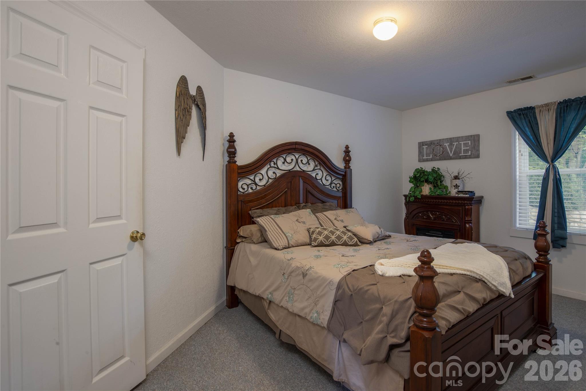 84 Sheets Farm Road Bakersville, NC 28705 - Photo 24 of 42 a bedroom with a bed and a painting on the wall