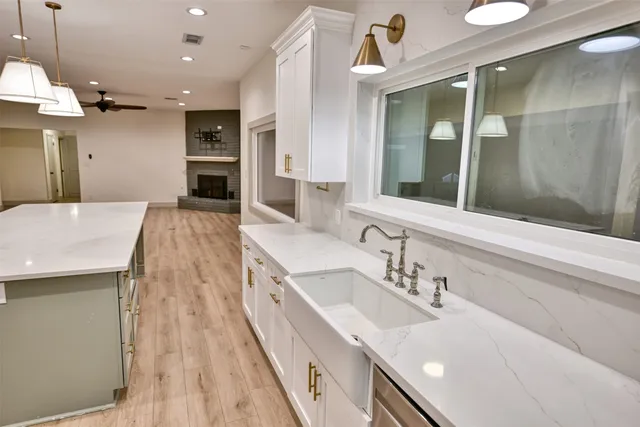 a spacious bathroom with a sink a large mirror and a shower