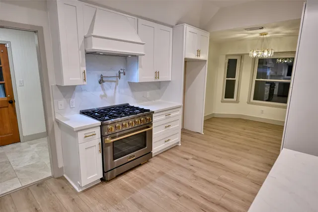 a kitchen with stainless steel appliances a stove and a refrigerator