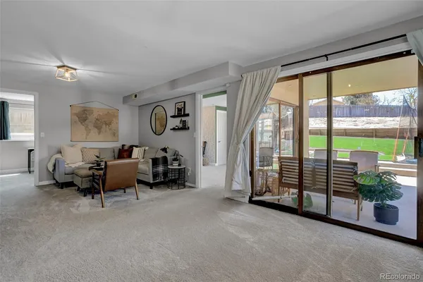 a living room with furniture and large windows