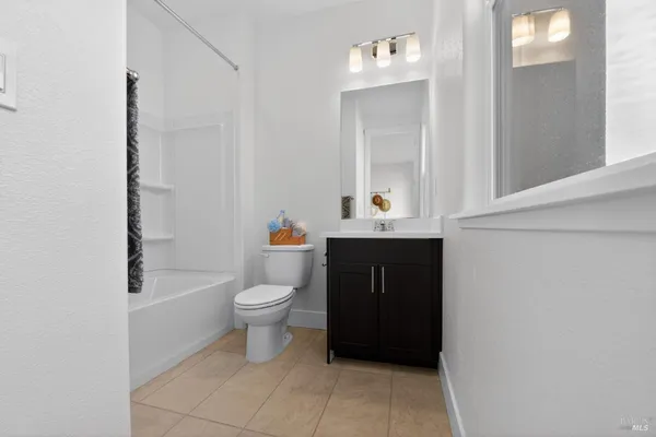 a bathroom with a toilet a sink and bathtub