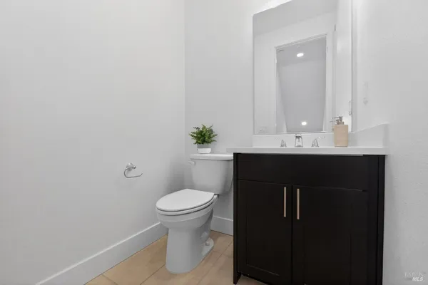 a bathroom with a sink toilet and a mirror