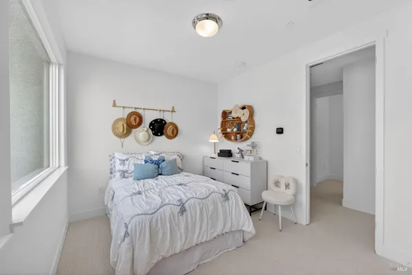 a bedroom with two bed and a window