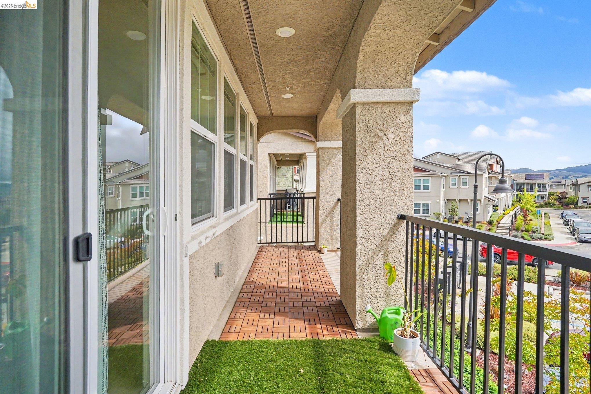 18210 Argento Loop San Ramon, CA 94583 - Photo 30 of 44 Expansive balcony featuring wood-finish tile flooring, recessed lighting, and black metal railings