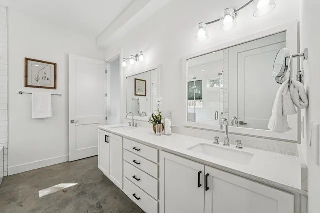 a bathroom with a double vanity sink mirror and double