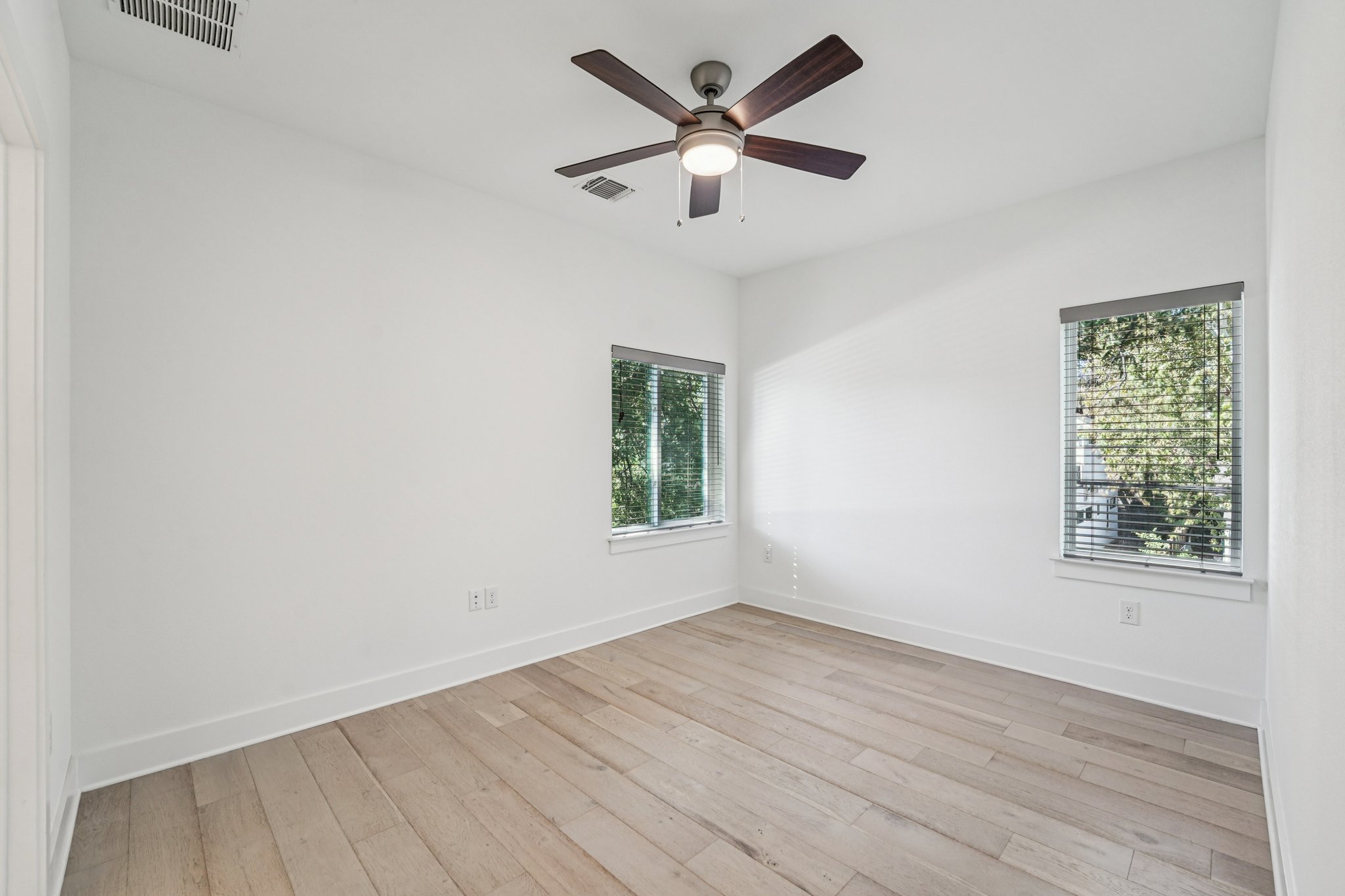 739 Gunter Street, Unit 1 Austin, TX 78702 - Photo 20 of 26 wooden floor in an empty room with a window