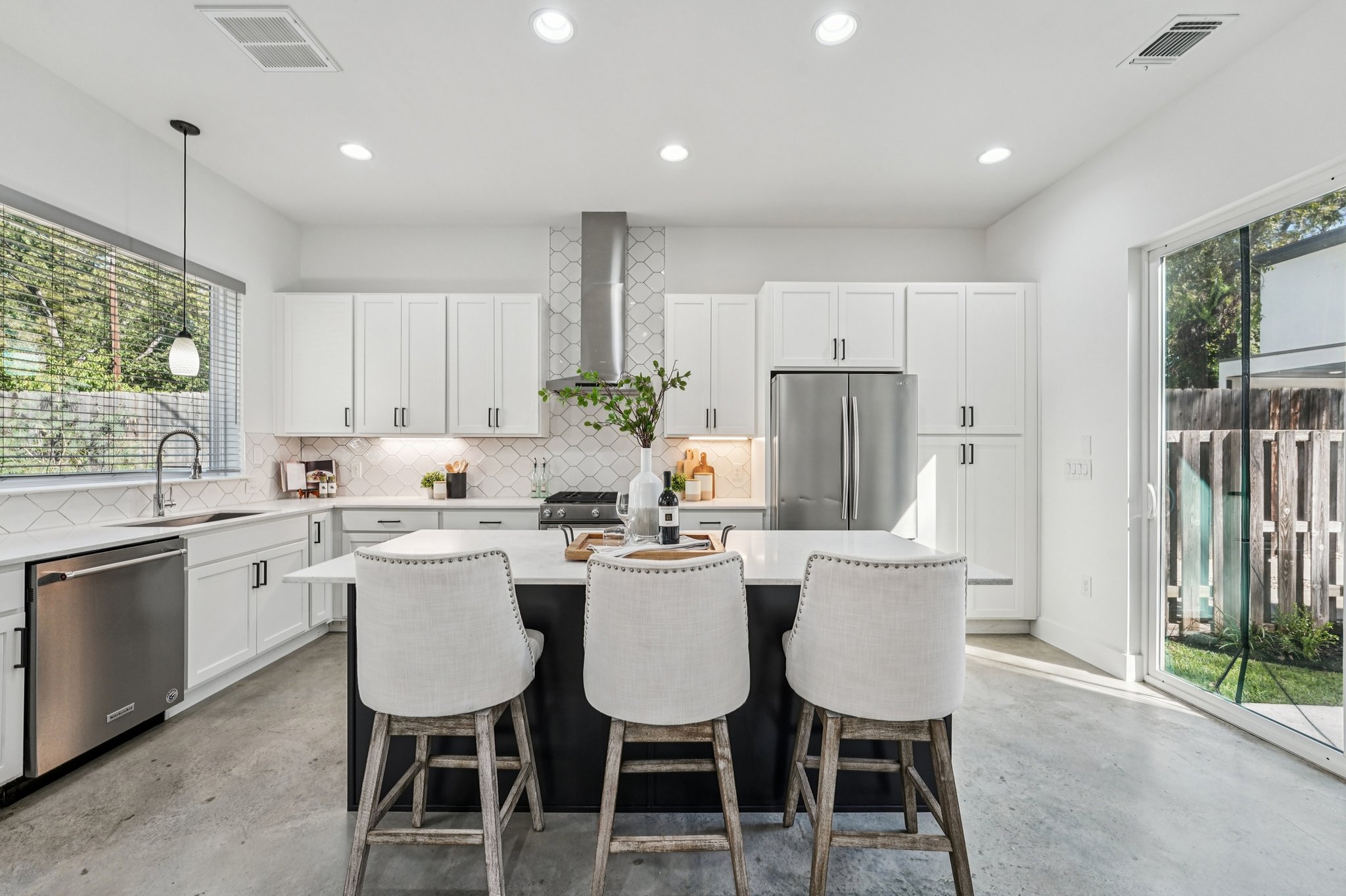 739 Gunter Street, Unit 1 Austin, TX 78702 - Photo 3 of 26 a kitchen with a dining table chairs and refrigerator