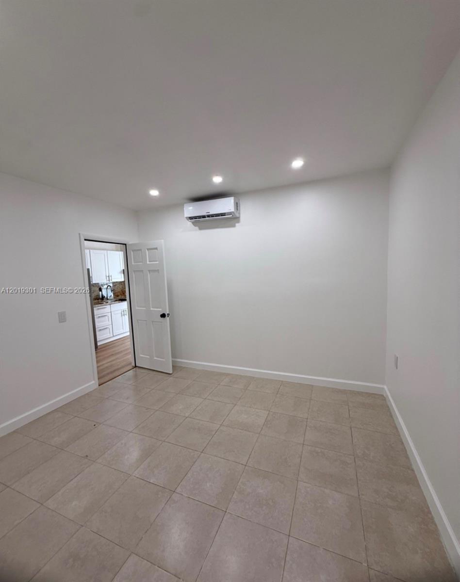 25948 Southwest 132nd Avenue, Unit 1 Homestead, FL 33032 - Photo 5 of 6 an empty room with staircase and bathroom