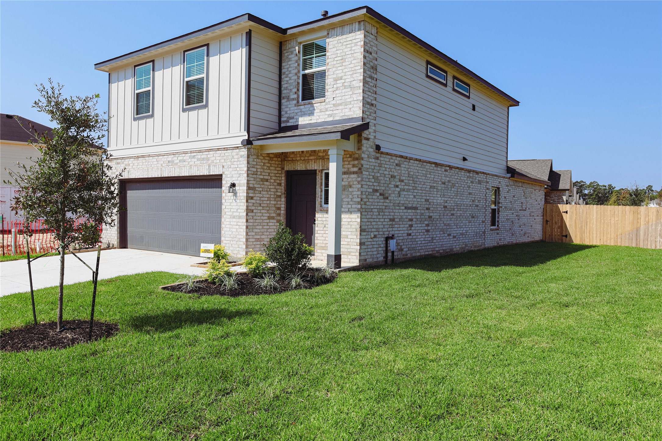 16 Courageous Way Magnolia, TX 77354 - Photo 2 of 19 a front view of a house with a garden and yard