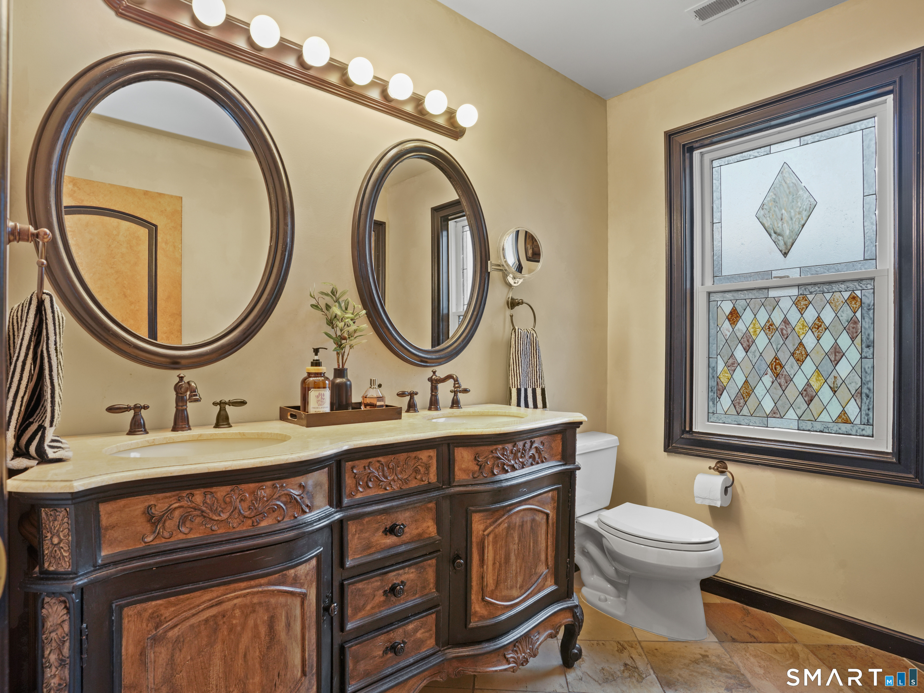 82 Ramapoo Road Ridgefield, CT 06877 - Photo 25 of 40 a bathroom with a toilet a sink and a mirror
