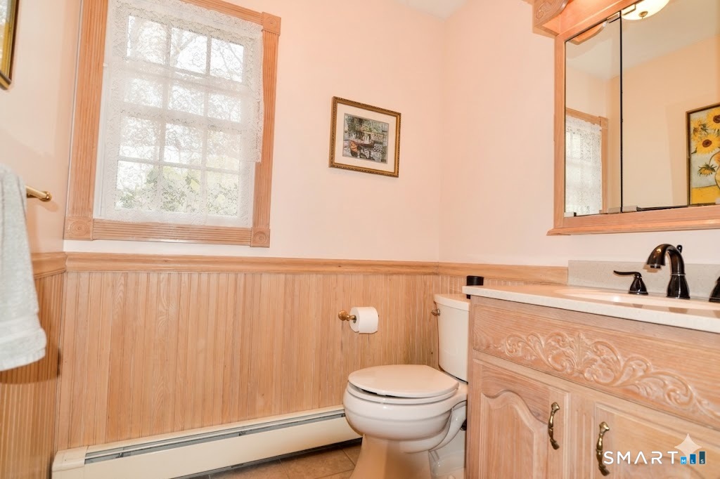 78 Mill Brook Terrace Monroe, CT 06468 - Photo 14 of 27 Main level, tile floor, wainscoting, corian sink counter