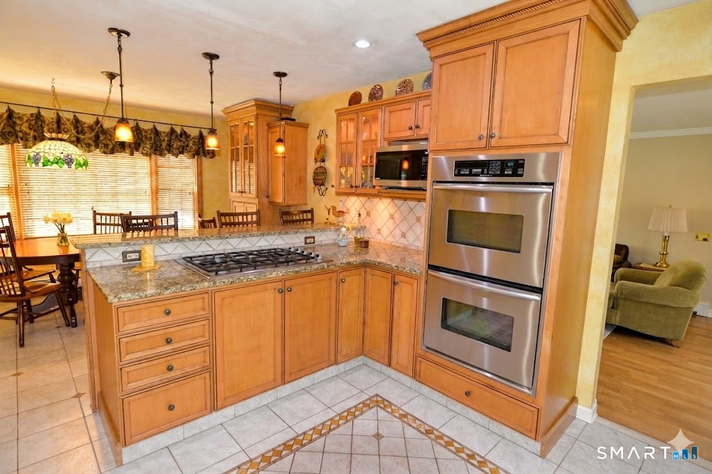 78 Mill Brook Terrace Monroe, CT 06468 - Photo 7 of 27 Breakfast bar, pendant lighting, granite countertops, gas cooktop + double electric oven, stainless steel appliances.