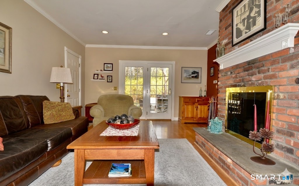 78 Mill Brook Terrace Monroe, CT 06468 - Photo 9 of 27 Wood-burning fireplace, built-in bookshelves, French doors to patio.
