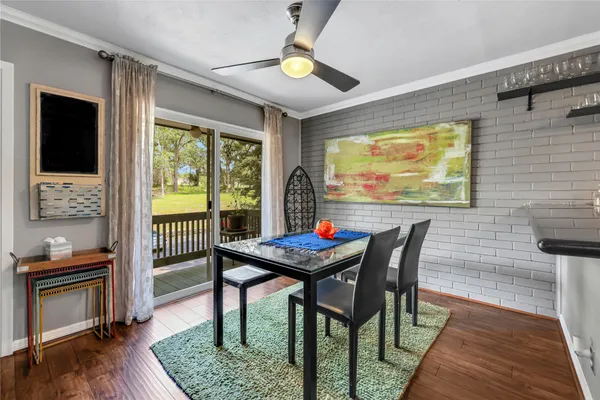 a dining room with furniture and wooden floor