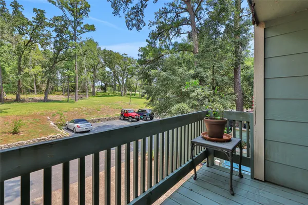 a view of balcony with wooden floor and outdoor seating