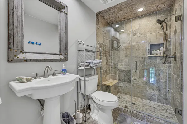 a bathroom with a sink toilet and shower
