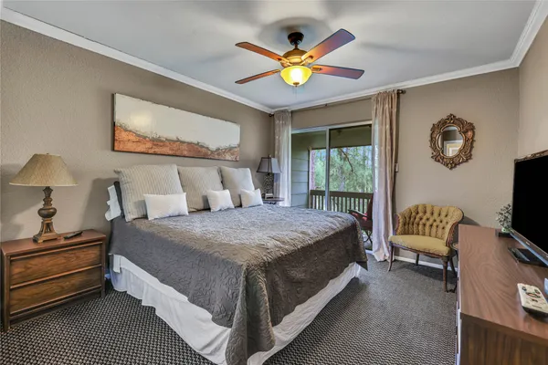 a bedroom with a bed and a painting on the wall