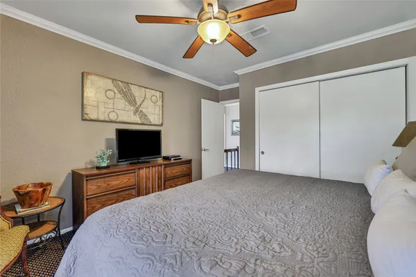 a bedroom with furniture and a flat screen tv