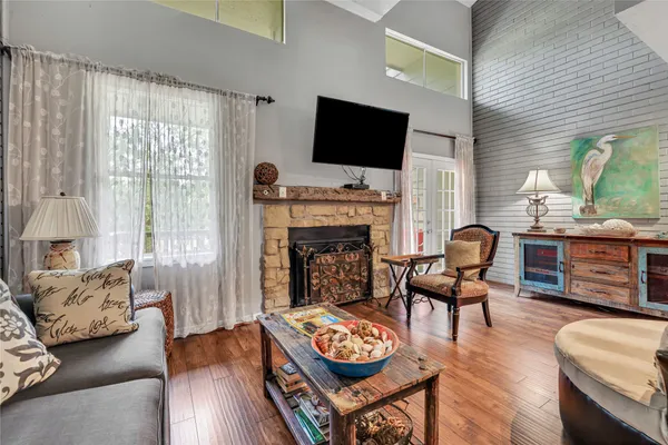 a living room with furniture a fireplace and a flat screen tv
