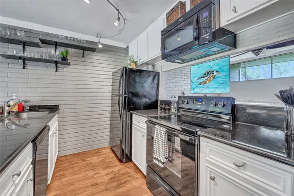 a kitchen with stainless steel appliances granite countertop a stove and a refrigerator
