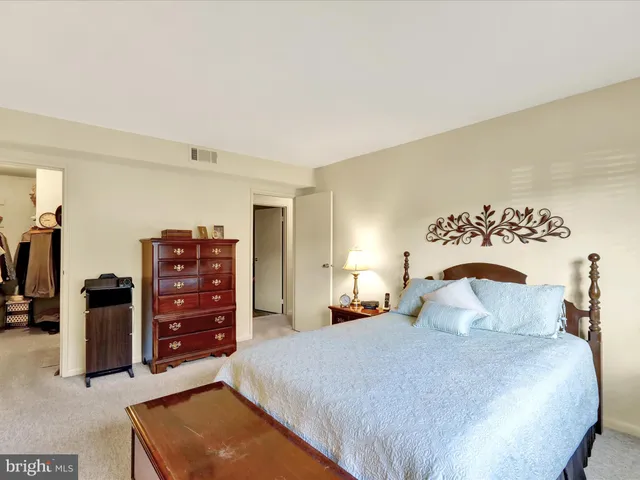 a bedroom with a bed and dresser