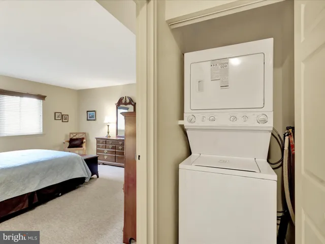 a view of bedroom with washer and dryer
