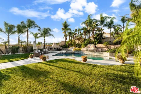 a view of a swimming pool with an outdoor space and seating area